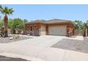 House exterior showcasing a two-car garage and desert landscaping at 15338 W Montecito Ave, Goodyear, AZ 85395