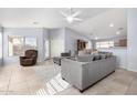 Spacious living room with gray sectional sofa and tile floors at 15548 N 156Th Ln, Surprise, AZ 85374