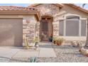 Front entry of home with stone facade, security door, and desert landscaping at 16005 S 10Th Pl, Phoenix, AZ 85048