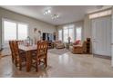 Living room with tiled floors, comfortable seating, and a dining area at 16005 S 10Th Pl, Phoenix, AZ 85048