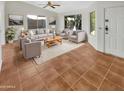 Bright living room featuring tile floors, neutral walls, and ample natural light at 18206 N 86Th Ln, Peoria, AZ 85382