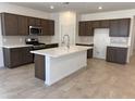 Bright kitchen with stainless steel appliances, white countertops, and central island at 20634 N 226Th Dr, Surprise, AZ 85387