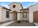 Home's entrance with arched entryway and brown door at 22847 E Sonoqui Blvd, Queen Creek, AZ 85142