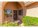 Covered entryway with a security door and lush landscaping at 24502 S Starcrest Dr, Sun Lakes, AZ 85248