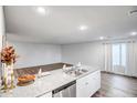 Kitchen island with granite countertops and a double sink at 24550 W Pima St, Buckeye, AZ 85326