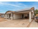 Street view of a home with solar panels and covered parking at 335 S Stardust Ln, Apache Junction, AZ 85120