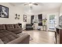 A spacious living room featuring wood floors, ceiling fan, and stylish decor at 335 S Stardust Ln, Apache Junction, AZ 85120