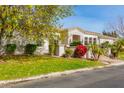 Exterior view of a beautiful house with stone accents and manicured lawn at 3412 E Indigo Cir, Mesa, AZ 85213