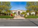 Charming home with desert landscaping, paved walkway, and wrought iron gate at 3412 E Indigo Cir, Mesa, AZ 85213