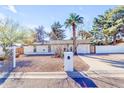 Well-kept one-story home with desert landscaping, a two-car garage, and a white perimeter fence at 4311 E Bluefield Ave, Phoenix, AZ 85032