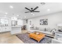 Open-concept living room and kitchen with modern design elements, neutral colors, and ample natural light at 4311 E Bluefield Ave, Phoenix, AZ 85032