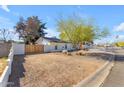 Yard featuring desert landscaping, privacy fence, and a view of the exterior of the home at 4311 E Bluefield Ave, Phoenix, AZ 85032