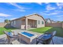 Landscaped backyard with fire pit and patio seating at 463 W Pinnacle Ridge Dr, San Tan Valley, AZ 85140