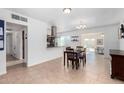 Open concept dining area with adjacent kitchen and access to the backyard at 481 W Ivanhoe Pl, Chandler, AZ 85225