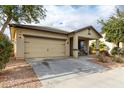 Single-story house, tan exterior, two-car garage, and a covered porch at 4908 S 244Th Ave, Buckeye, AZ 85326