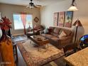 Living room features a brown leather couch and wood-toned coffee table at 5450 E Deer Valley Dr # 1204, Phoenix, AZ 85054