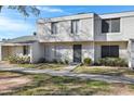 Two-story condo with light-colored siding, a walkway, and landscaping at 6415 S El Camino Dr, Tempe, AZ 85283