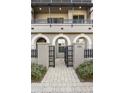 Townhouse entrance with a gate and paved walkway at 6565 E Thomas Rd # 1141, Scottsdale, AZ 85251