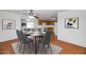 Dining area with a square table, gray chairs, and a view into the kitchen at 6730 W Vernon Ave, Phoenix, AZ 85035