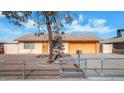 Ranch-style home with an attached garage and chain link fence at 6730 W Vernon Ave, Phoenix, AZ 85035