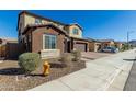 Two-story house on a residential street with landscaping and a three-car garage at 7214 W Buckhorn Trl, Peoria, AZ 85383