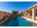 Relaxing pool area with waterfall and patio seating at 8833 W Tierra Buena Ln, Peoria, AZ 85382