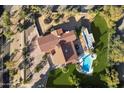 Aerial view showcasing the home's layout, pool, and surrounding landscape at 8915 N Invergordon Rd, Paradise Valley, AZ 85253