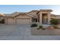 Single-story home with a two-car garage and desert landscaping at 9439 E Palm Tree Dr, Scottsdale, AZ 85255