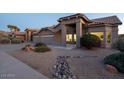 House exterior with a covered entryway and rock landscaping at 9439 E Palm Tree Dr, Scottsdale, AZ 85255