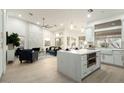 Spacious kitchen with island, stainless steel appliances, and white cabinets at 9439 E Palm Tree Dr, Scottsdale, AZ 85255