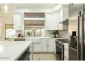 Updated kitchen with white cabinets, farm sink, and stainless steel appliances at 9439 E Palm Tree Dr, Scottsdale, AZ 85255