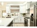 Bright kitchen featuring white cabinets, stainless steel appliances, and a farmhouse sink at 9439 E Palm Tree Dr, Scottsdale, AZ 85255