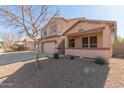 Two-story house with a three-car garage and covered porch at 10325 W Windsor Ave, Avondale, AZ 85392