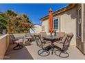 Outdoor patio furniture with a table and chairs under an umbrella at 10334 W Sunbird Dr, Arizona City, AZ 85123