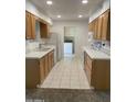 Eat-in kitchen with light wood cabinets and tile flooring at 10630 W Roundelay Cir, Sun City, AZ 85351