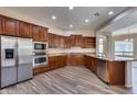 Modern kitchen boasts wood cabinetry, granite counters, and stainless steel appliances at 12629 W Bajada Rd, Peoria, AZ 85383