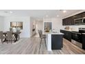 Open concept kitchen and dining area with island, hardwood floors, and modern fixtures at 1321 W Inca Dr, Coolidge, AZ 85128