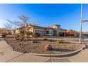 House with a large front yard, gravel landscaping, and a circular driveway at 14836 W Desert Hills Dr, Surprise, AZ 85379