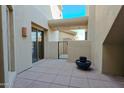 Private patio with tiled flooring, gate, and potted plants at 14850 E Grandview Dr # 138, Fountain Hills, AZ 85268