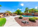 Inviting backyard oasis with a sparkling pool and built-in BBQ at 16205 S 7Th St, Phoenix, AZ 85048