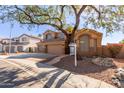 Two-story house with a three-car garage and mature shade tree at 16205 S 7Th St, Phoenix, AZ 85048