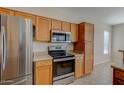 Modern kitchen with stainless steel appliances and ample wood cabinetry at 169 E Canary Ct, San Tan Valley, AZ 85143