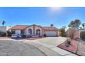 Single-story home with red tile roof, arched entryway, and landscaped front yard at 1745 N Terrace Cir, Casa Grande, AZ 85122