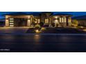 Stunning curb appeal with desert landscaping at night at 17904 E Veit Springs Dr, Rio Verde, AZ 85263