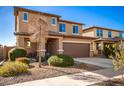 Two-story house with a brown garage door and landscaped front yard at 18475 W Via Del Sol --, Surprise, AZ 85387