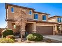 Two-story house with a brown garage door and landscaped front yard at 18475 W Via Del Sol --, Surprise, AZ 85387