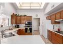 Bright kitchen with wood cabinets, ample counter space, and stainless steel appliances at 19633 N Marble Dr, Sun City West, AZ 85375