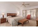 Large bedroom with a king-size bed, nightstands, and a comfy armchair at 19633 N Marble Dr, Sun City West, AZ 85375