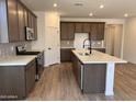 Modern kitchen featuring stainless steel appliances, a quartz countertop island, and stylish cabinetry at 20612 N 226Th Dr, Surprise, AZ 85387