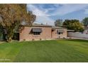 Brick house with a lush lawn and carport at 2112 W Mulberry Dr, Phoenix, AZ 85015